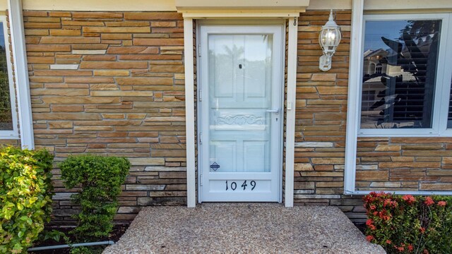 entrance to property featuring stone siding