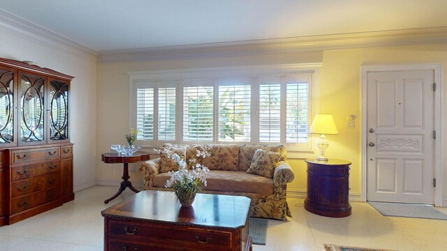 living area with a healthy amount of sunlight, crown molding, and baseboards