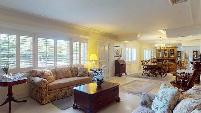 living room featuring a notable chandelier and crown molding