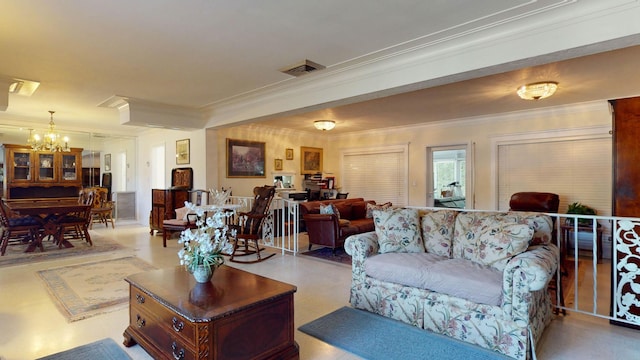 living room featuring visible vents, crown molding, and a notable chandelier