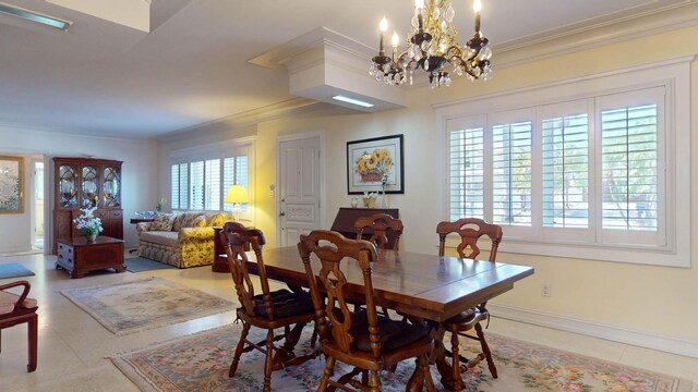 dining room with a chandelier, ornamental molding, and baseboards