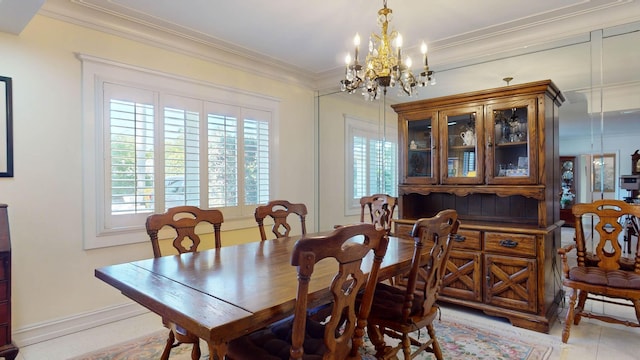 dining area featuring a chandelier and crown molding