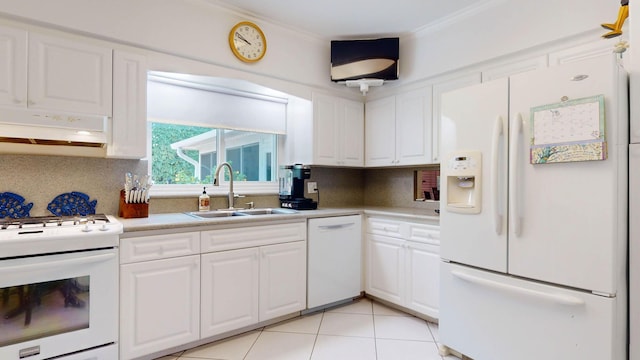 kitchen featuring under cabinet range hood, white appliances, a sink, light countertops, and backsplash