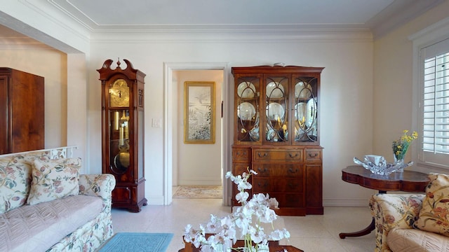 living room featuring baseboards, ornamental molding, and tile patterned floors