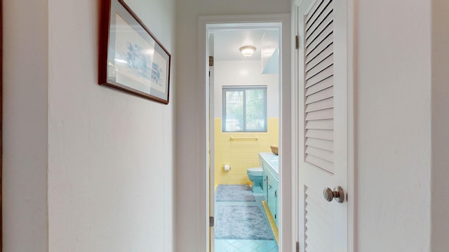 hallway featuring tile walls