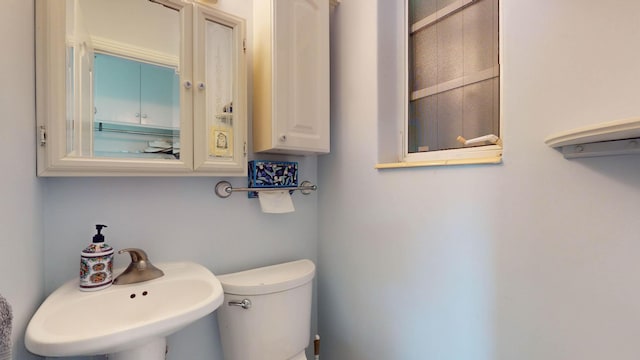 bathroom featuring toilet and a sink