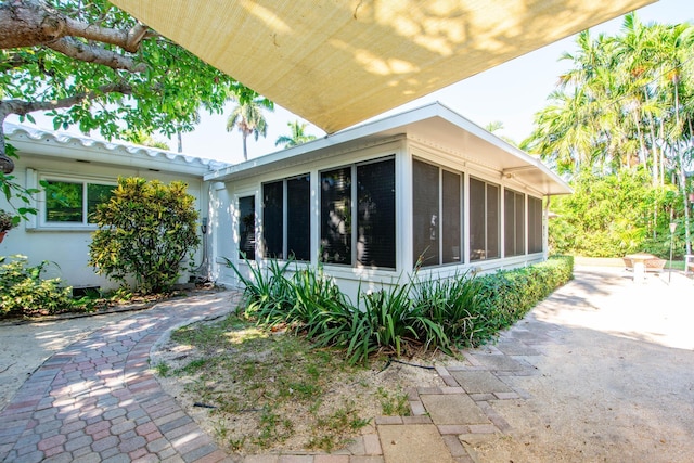 view of home's exterior with a sunroom