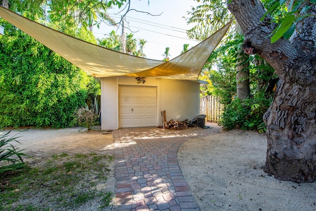 detached garage featuring fence