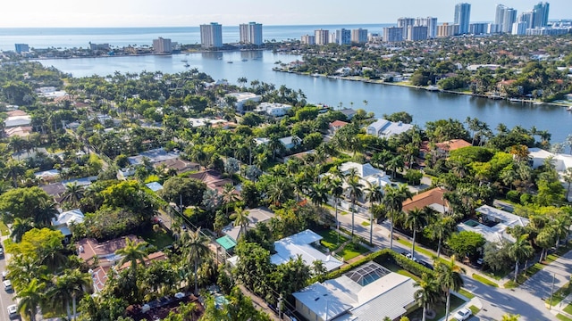 birds eye view of property with a water view and a city view