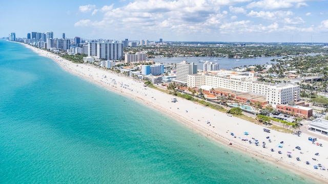 aerial view featuring a water view, a view of city, and a beach view