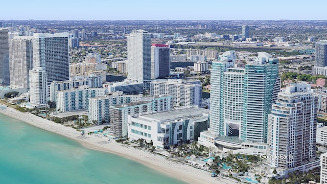 property's view of city featuring a water view and a view of the beach