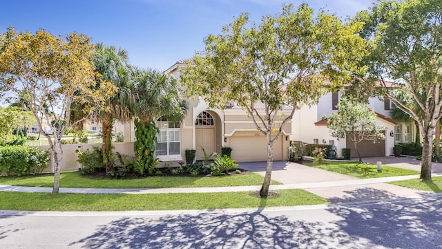 view of front of property featuring a garage and a front yard