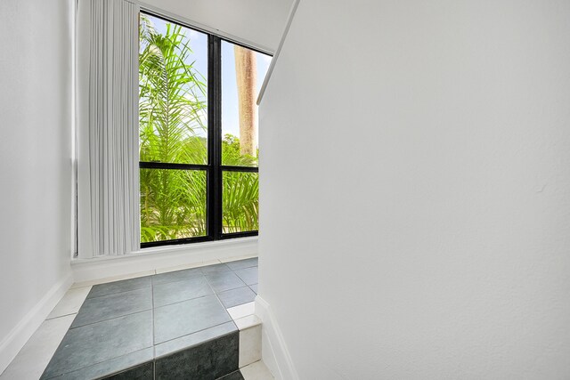 entryway featuring light tile patterned floors and plenty of natural light