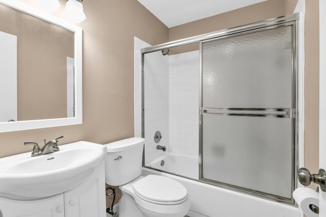 full bathroom featuring vanity, bath / shower combo with glass door, and toilet