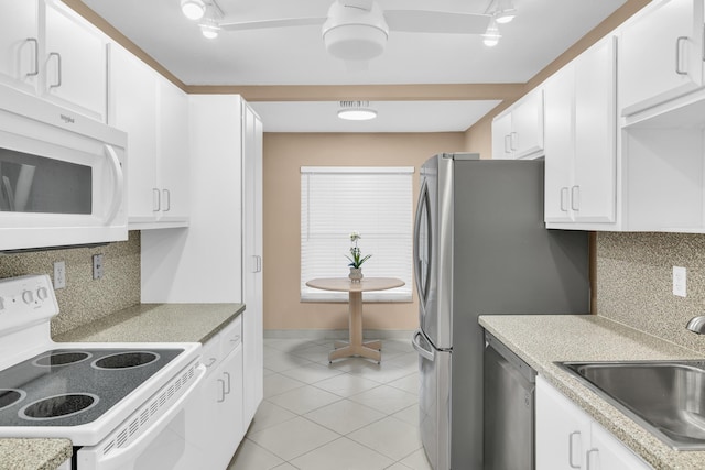 kitchen with white cabinetry, sink, white appliances, and decorative backsplash