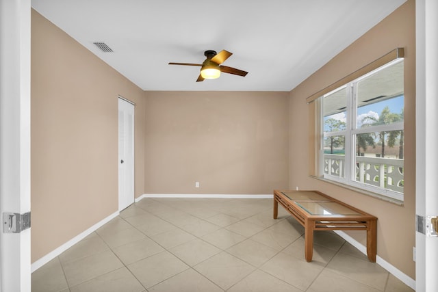 unfurnished room featuring ceiling fan and light tile patterned floors