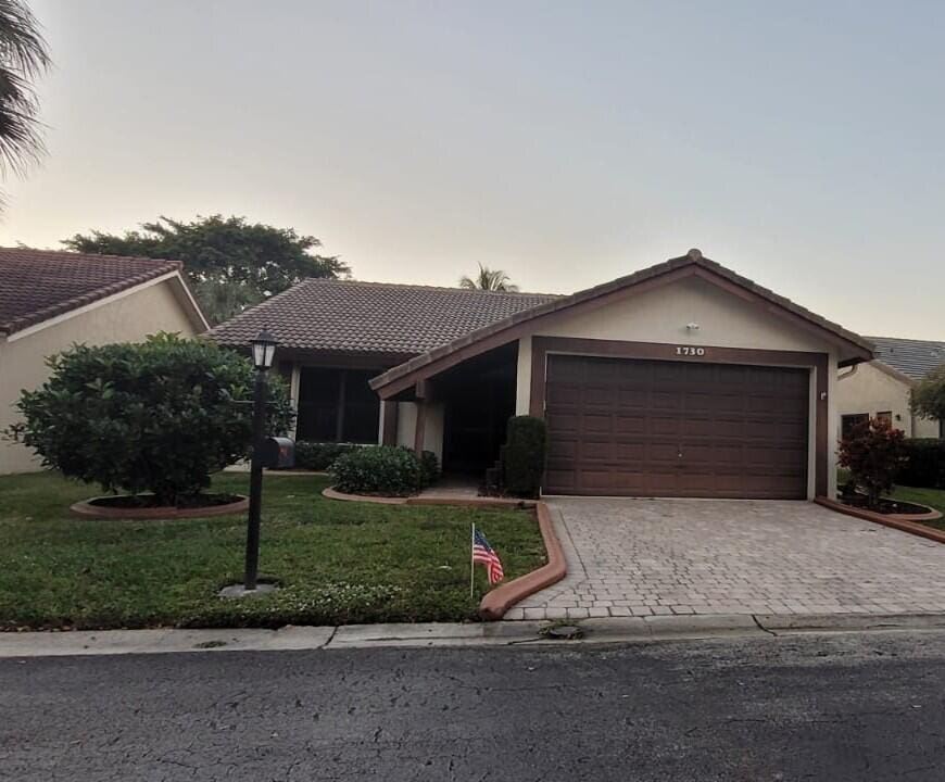 ranch-style house with a lawn and a garage