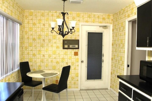 tiled dining space with an inviting chandelier