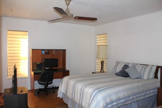 bedroom with ceiling fan and dark hardwood / wood-style flooring