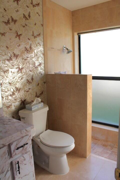 bathroom with tile patterned flooring and toilet