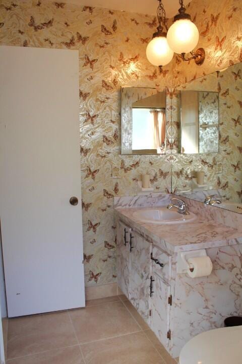 bathroom with tile patterned flooring, vanity, and toilet