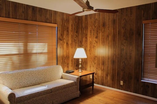 living area featuring light hardwood / wood-style flooring and wood walls