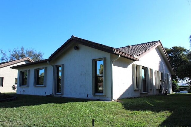 view of home's exterior featuring a yard