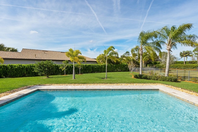 view of swimming pool with fence, a fenced in pool, and a yard