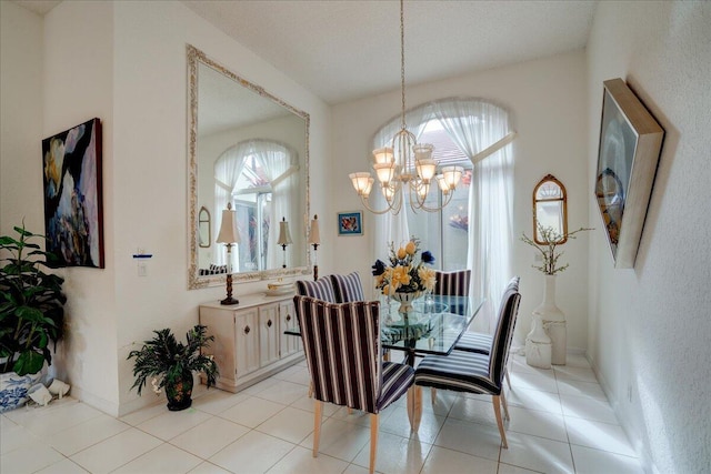 tiled dining room with a textured ceiling and a chandelier