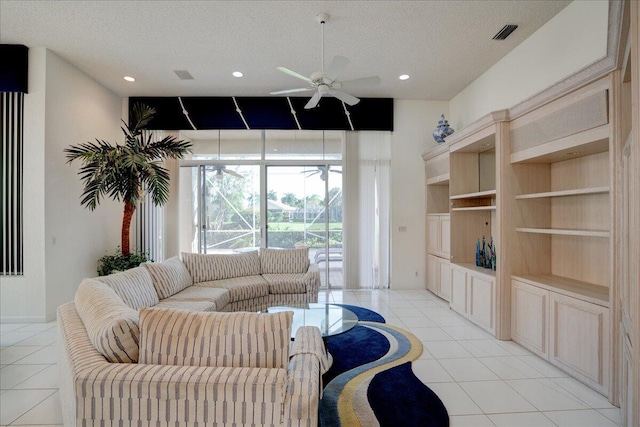 tiled living room featuring ceiling fan and a textured ceiling