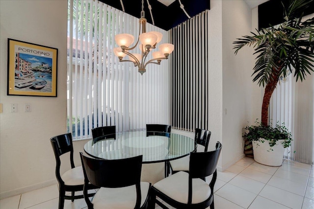 tiled dining space with a chandelier