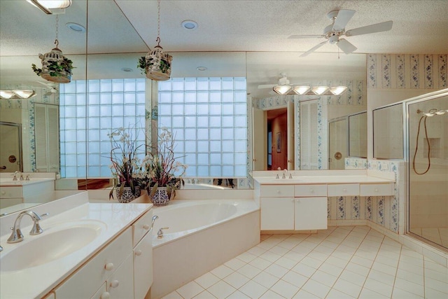 bathroom with shower with separate bathtub, tile patterned flooring, and a textured ceiling