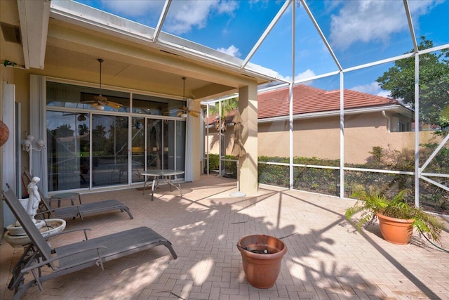 view of patio / terrace featuring ceiling fan and a lanai