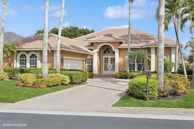 view of front of home with french doors and a garage