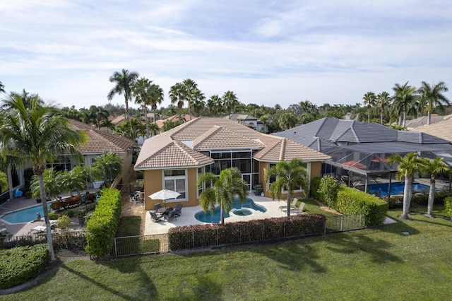 back of property featuring a fenced in pool, a patio, a lanai, and a lawn