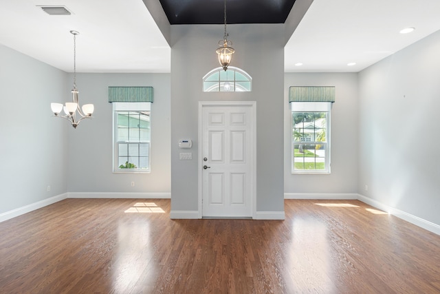 foyer with a notable chandelier and hardwood / wood-style floors