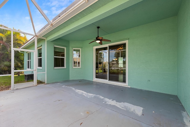 unfurnished sunroom featuring ceiling fan