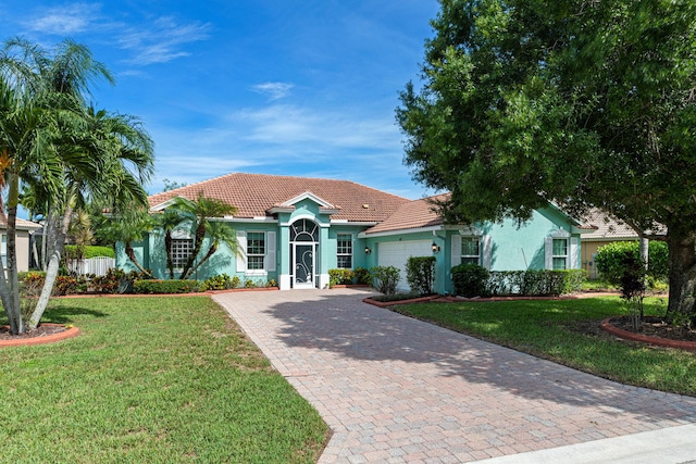 view of front of property featuring a garage and a front lawn