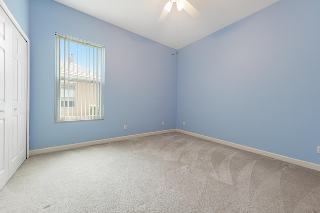 carpeted empty room with ceiling fan