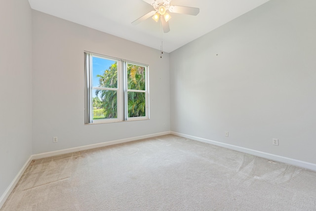 empty room with ceiling fan and light colored carpet