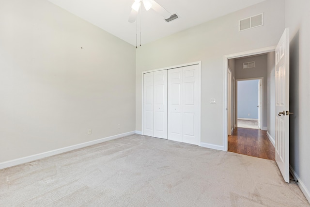 unfurnished bedroom with ceiling fan, a closet, and carpet floors