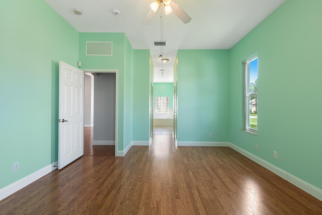 unfurnished bedroom with ceiling fan and dark hardwood / wood-style floors