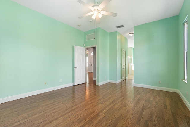 empty room with ceiling fan and dark hardwood / wood-style floors