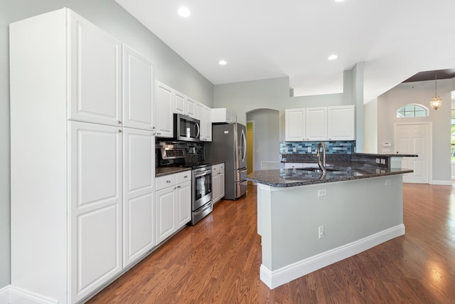 kitchen featuring backsplash, white cabinetry, appliances with stainless steel finishes, and sink