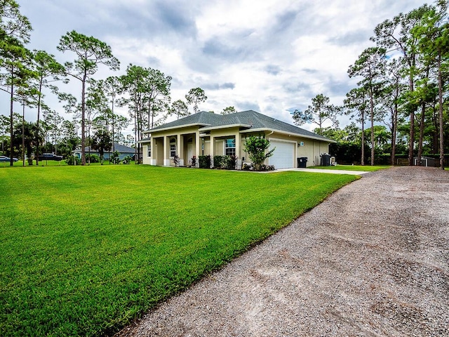 view of front of property featuring a garage and a front yard