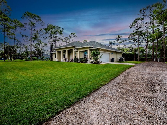 view of front facade featuring a garage and a lawn