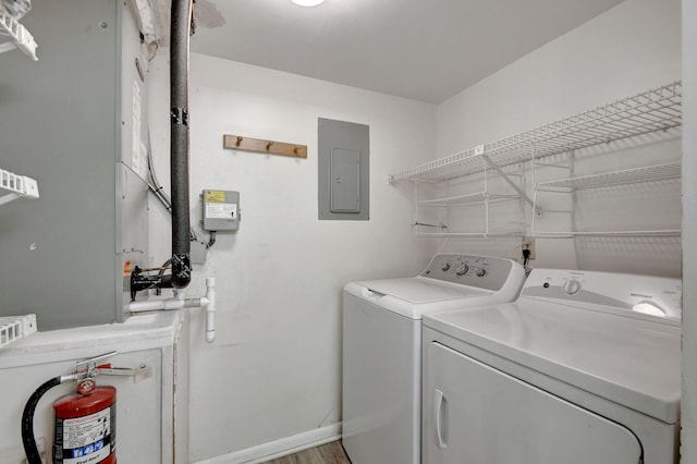 clothes washing area with electric panel and washing machine and clothes dryer