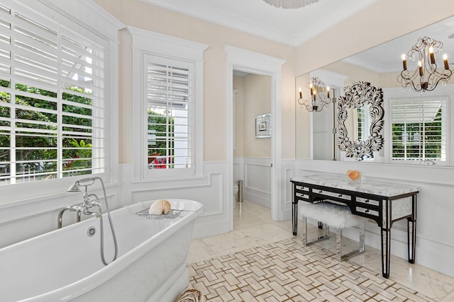 bathroom with a bathtub, ornamental molding, and a chandelier