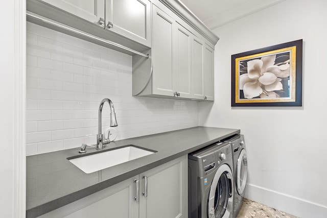 laundry room with separate washer and dryer, sink, crown molding, and cabinets