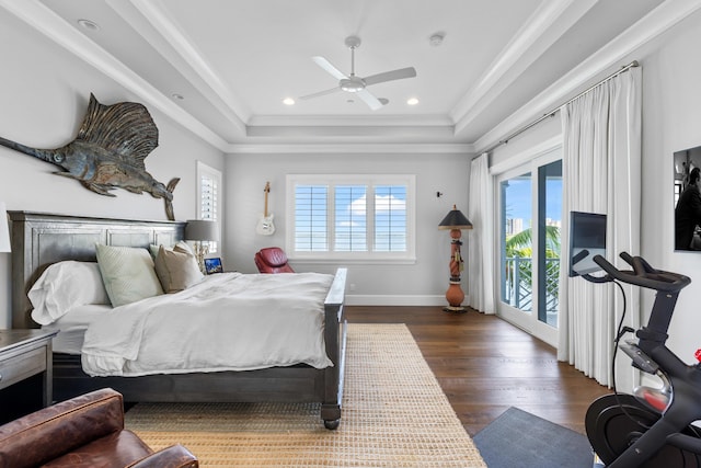 bedroom with dark hardwood / wood-style flooring, access to exterior, a raised ceiling, and ceiling fan